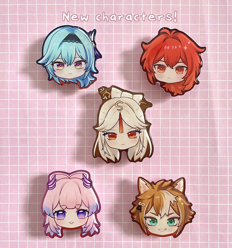 May include: Five chibi-style character pins arranged on a grid background with the text New characters! at the top. The pins feature stylized heads with distinct hair colors including light blue, red, white, pink, and brown with animal ears.