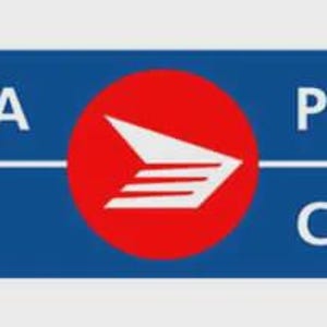 May include: A blue rectangular sign with the words "CANADA POST" and "POSTES CANADA" in white. A red circle in the center features a white stylized bird or arrow design. The sign is for the Canadian postal service.