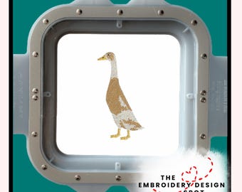 May include: An embroidery design of a duck with a brown body, white and brown wings, and a yellow beak and feet. The design is framed in a square embroidery hoop. The text "THE EMBROIDERY DESIGN SPOT" is below the hoop.