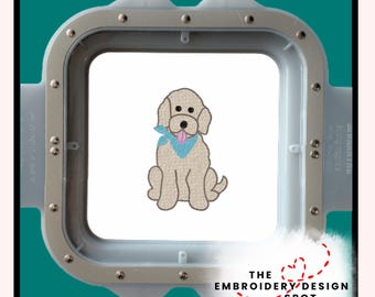 May include: An embroidered design of a light brown dog with a blue bandana and pink tongue, sitting on a white background. The design is in a silver embroidery hoop. The text "THE EMBROIDERY DESIGN SPOT" is below the design.