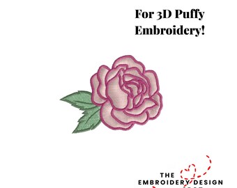 May include: A detailed embroidery design of a pink rose with green leaves. The text "For 3D Puffy Embroidery!" is above the rose. The Embroidery Design Spot logo is below the rose on a white background.