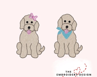 May include: Two embroidered dog designs. One dog has a pink bow, the other a blue bandana. Both dogs are tan with black eyes and noses, and pink tongues. The text "THE EMBROIDERY DESIGN SPOT" is below the dogs.