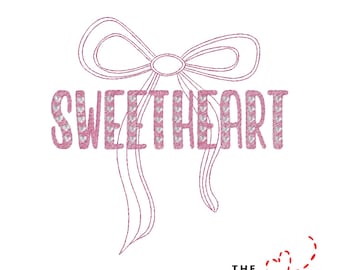 May include: A pink embroidered design featuring the word "SWEETHEART" in a decorative font, with a bow above and below the text. The design is on a white background. The text "THE EMBROIDERY DESIGN SPOT" is at the bottom.