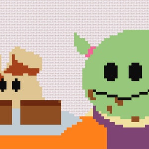 May include: A green, cartoon-like character with brown eyes and a purple shirt is smiling. The character has brown spots on its face and is looking at a plate of two brown chocolate squares. A tan, cartoon-like character with brown eyes and brown spots is behind the plate.