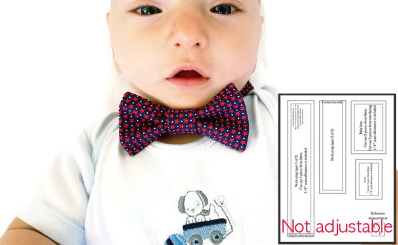 May include: A baby wearing a white shirt with a red and blue bow tie with white stars. The bow tie is not adjustable. The shirt has a small embroidered design of a dog on a toy car.