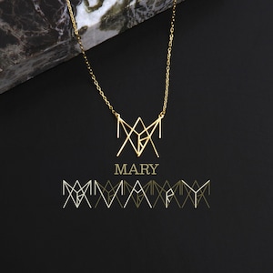 May include: A gold necklace with a geometric pendant that spells out the name "MARY". The pendant is made of thin, interconnected lines that form a unique design. The necklace is displayed on a black background with a marble surface in the background.