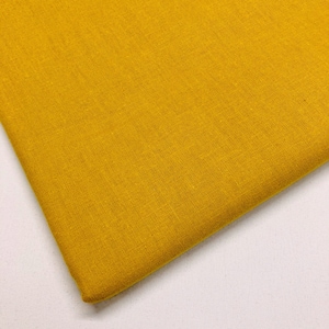 May include: A close-up of a piece of solid yellow fabric with a textured weave.