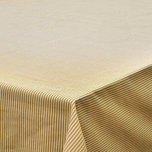 May include: A white tablecloth with thin, gold stripes. The tablecloth is folded in half, showing the stripes on both sides.