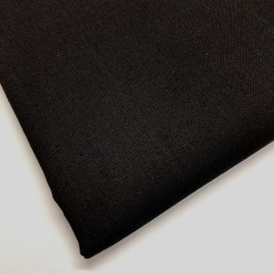 May include: Black fabric with a smooth, slightly textured surface.