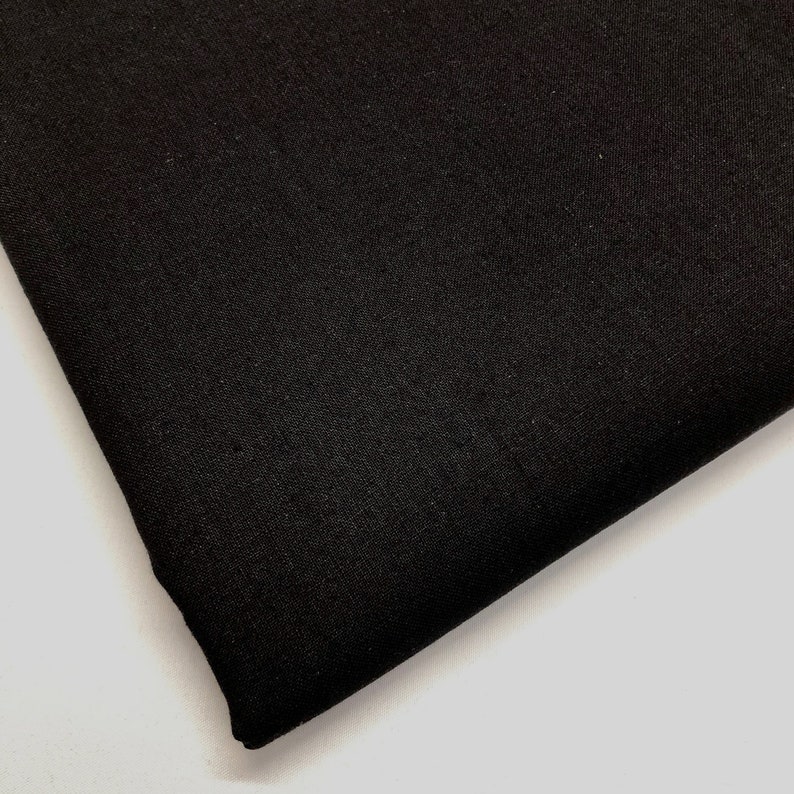 May include: Black fabric with a smooth, slightly textured surface.