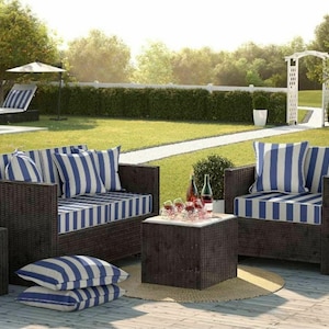 Puede incluir: Un conjunto de muebles de jard&iacute;n de mimbre marr&oacute;n con cojines a rayas azules y blancas. El conjunto incluye un sof&aacute; de dos plazas, dos sillones, una mesa de caf&eacute; y cojines. Los muebles est&aacute;n dispuestos en una terraza de madera en un jard&iacute;n.