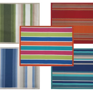 May include: Five striped placemats in different colour combinations. The placemats are made of a woven material and have a subtle sheen. The colours include green, white, beige, red, orange, blue, turquoise, pink, and yellow.