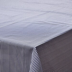 May include: A white tablecloth with black stripes. The tablecloth is folded in half and the stripes are running vertically.