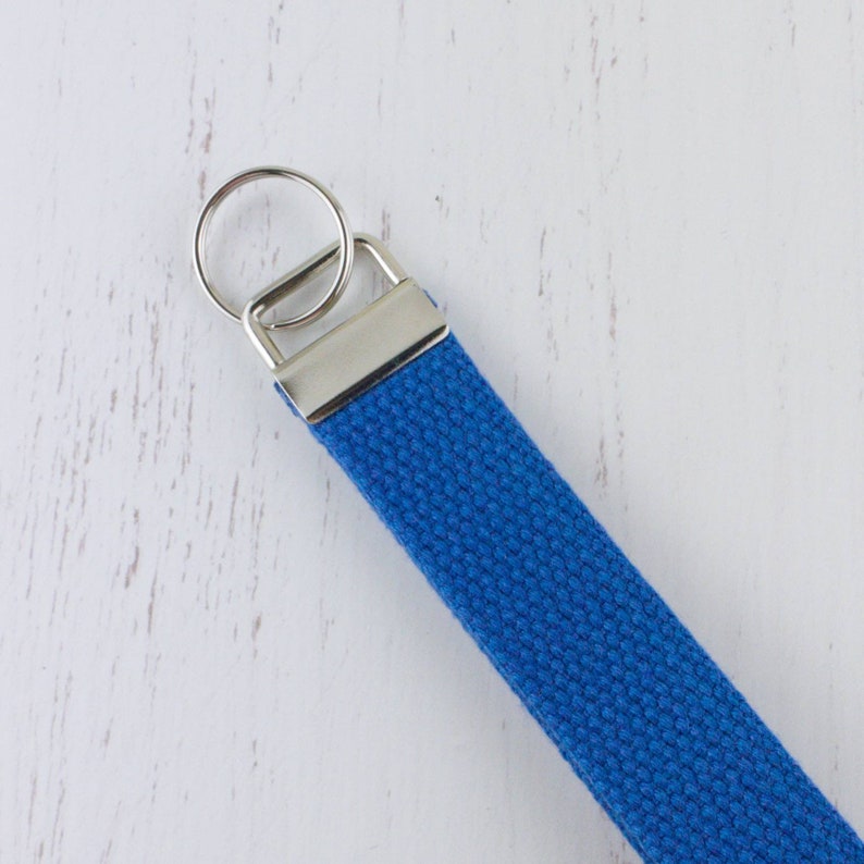 May include: A blue canvas key chain with a silver key ring.