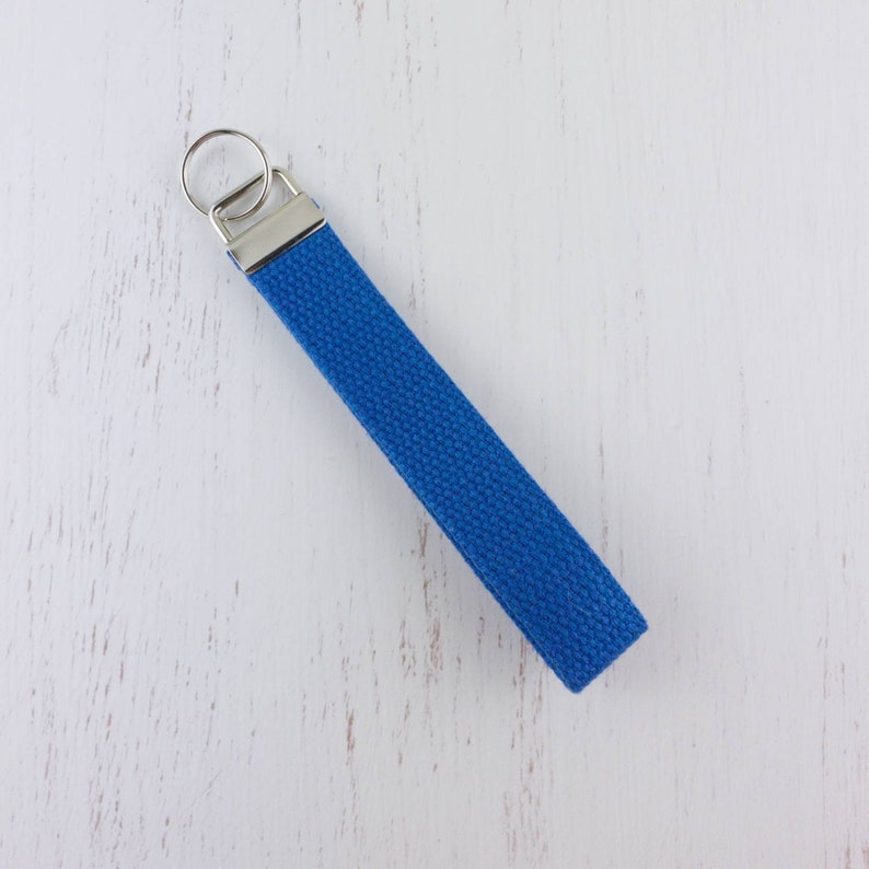 May include: A blue canvas key chain with a silver key ring.