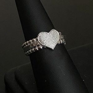 sterling silver fingerprint ring. Handmade Fingerprint is attached to the center square wire band. You can feel the deep engraving of the imprint. There are stacking bands on each side made from bead wire.