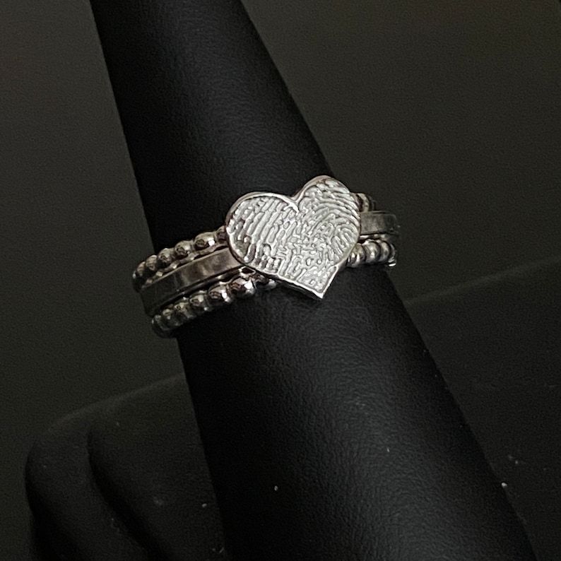 sterling silver fingerprint ring. Handmade Fingerprint is attached to the center square wire band. You can feel the deep engraving of the imprint. There are stacking bands on each side made from bead wire.