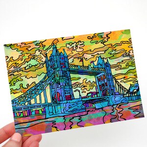 May include: A colorful illustration of the Tower Bridge in London, England. The bridge is depicted in shades of blue, green, and yellow, with a stylized, abstract background of clouds.