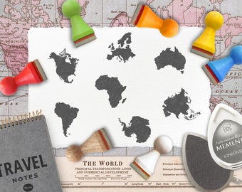 May include: A set of seven rubber stamps featuring outlines of the continents of the world. The stamps are arranged on a white surface with a vintage world map in the background. The stamps are in various colors, including red, green, yellow, and blue.