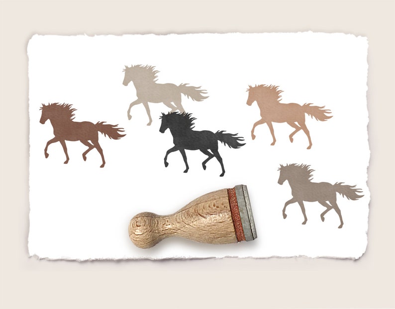May include: A wooden rubber stamp with a brown handle and a red rubber base. The stamp features four different silhouettes of horses in various shades of brown and black.