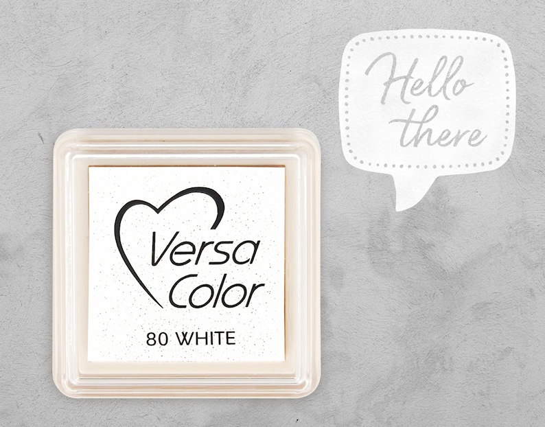 May include: White ink pad with a heart and the text "Versa Color 80 WHITE" in black. The ink pad is in a clear plastic case.