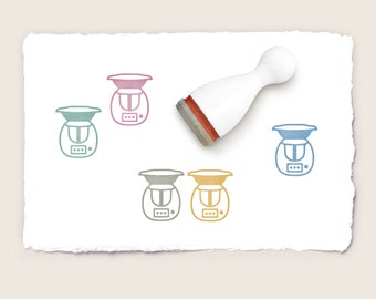 May include: Five rubber stamps with a kitchen appliance design. The stamps are in different colors: pink, blue, green, gray, and yellow. The stamps are on a white paper background.