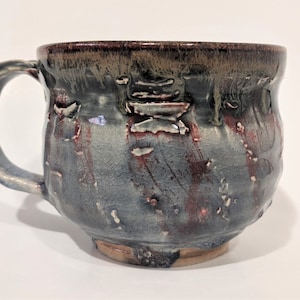 Textured tea or hot chocolate mug with handle.