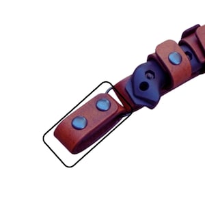 May include: A brown leather strap with two silver metal rivets. The strap is attached to a black leather strap with a metal buckle.