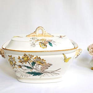 May include: A set of three ceramic mugs with a speckled, matte finish. Each mug features a different color: light blue, cream, and gray. The mugs have a simple, modern design and a comfortable handle.