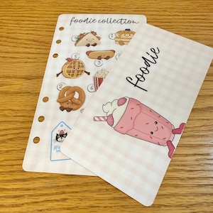 May include: A set of three ceramic mugs with a speckled, matte finish. Each mug features a different color: light blue, cream, and gray. The mugs have a simple, modern design with a rounded shape and a comfortable handle.