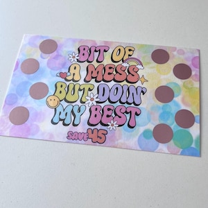 May include: A colorful card with a rainbow background and white polka dots. The card says "Bit of a mess but doin' my best" in a retro font. The text "Save 45" is at the bottom of the card.