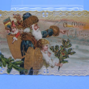 Rare carte postale antique du Père Noël en costume bleu gaufré et découpée sur les bords