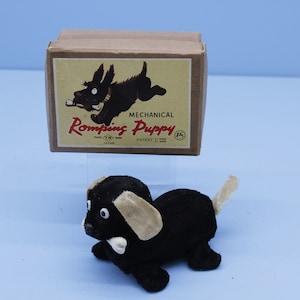 Vintage Japan T.N. Mechanical Romping puppy windup toy in original box.