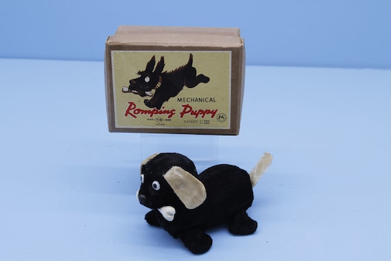 Vintage Japan T.N. Mechanical Romping puppy windup toy in original box.