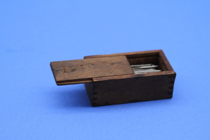 Vintage miniature wooden dovetail box with sliding lid and sewing needles