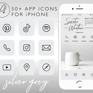Peut inclure: Une maquette d'iPhone blanche sur un fond gris argenté. L'écran du téléphone affiche un widget de calendrier avec le texte "Sweater Weather" et une liste d'icônes d'applications, notamment Téléphone, Pinterest, Youtube et Instagram. Le texte "50+ APP ICONS FOR IPHONE" est affiché au-dessus de la maquette du téléphone.