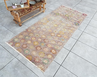 May include: A vintage style rug with a floral pattern in shades of brown, beige, and cream. The rug has a distressed look and is perfect for adding a touch of vintage charm to any room.