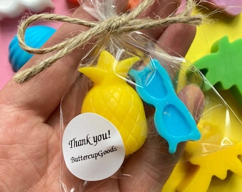 May include: A small clear plastic bag filled with colourful soap favours. The bag is tied with twine and includes a pineapple, sunglasses, and a palm tree. A sticker on the bag reads "Thank you! ButtercupGoods".