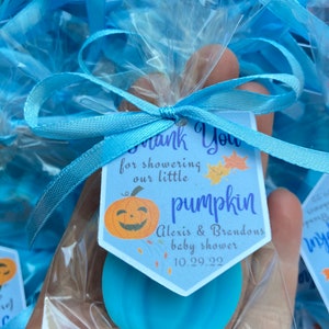 May include: Blue pumpkin shaped soap favors with a thank you tag that reads "Thank You for showering our little pumpkin Alexis & Brandons baby shower 10.29.22".
