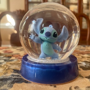 Disney Lilo & Stitch Glitter Globe Atop A Colorful Base Adorned