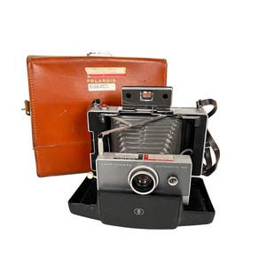 Appareil photo Polaroid 100 Land automatique vintage/Appareil photo Polaroid pliant avec étui en cuir et manuel
