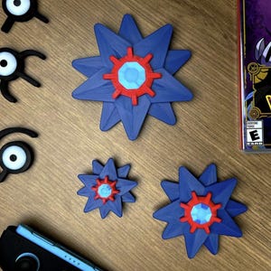 Starmie pokemon fidget spinners on a table