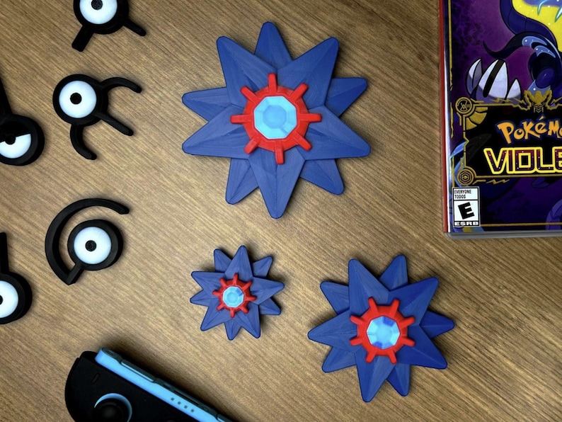 Starmie pokemon fidget spinners on a table