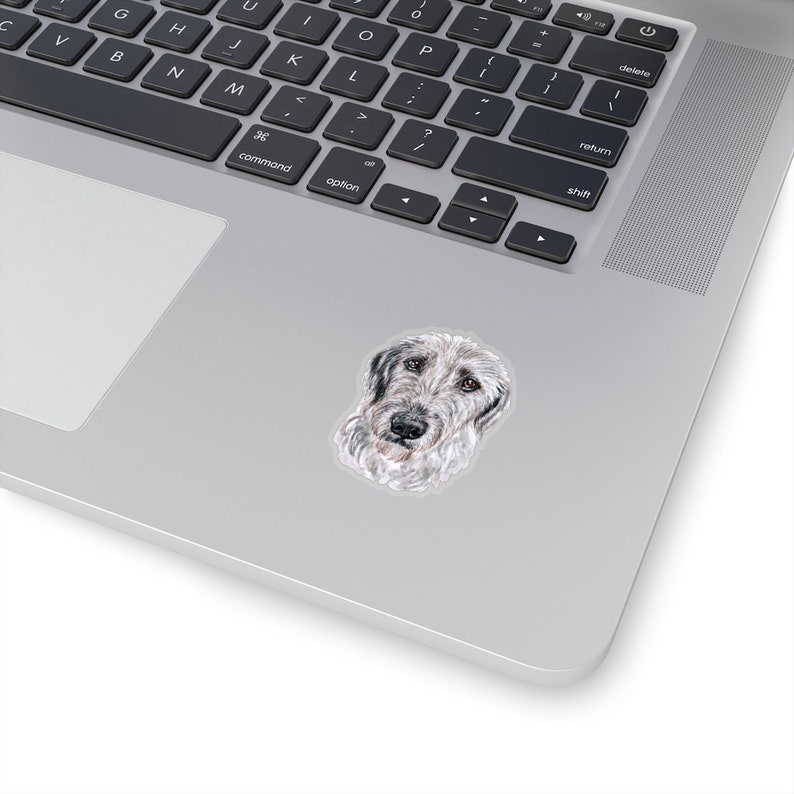 May include: A watercolor illustration of a grey and white Irish Wolfhound dog with a serious expression. The dog's head and neck are visible, and the background is white.