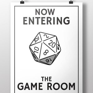May include: A white sign with black text that reads "NOW ENTERING THE GAME ROOM". A black and white illustration of a twenty-sided die is in the center of the sign.