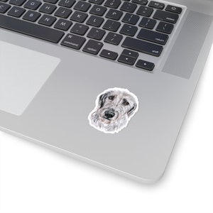 May include: A watercolor illustration of an Irish Wolfhound dog with a white and gray coat. The dog is looking directly at the viewer with a serious expression.
