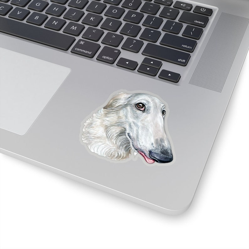 May include: A white Borzoi dog with a long snout and floppy ears. The dog is looking to the right and has its tongue sticking out.