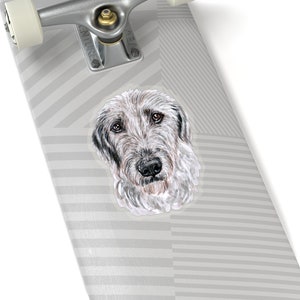 May include: A sticker featuring a watercolor illustration of an Irish Wolfhound dog's head. The dog has a white and gray coat, with black eyes and nose. The background is a gray and white striped pattern.