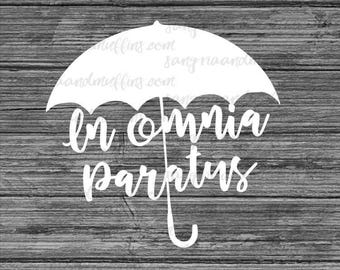 May include: A white vinyl decal featuring the silhouette of an umbrella with a curved handle. The text "In omnia paratus" is written in a white cursive script across the center of the umbrella canopy, set against a dark gray wood grain background.