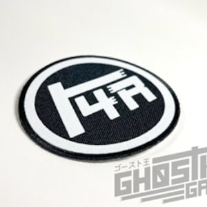 May include: Black and white embroidered patch with the text "4A" in a circle. The patch is made of fabric and has a white border.